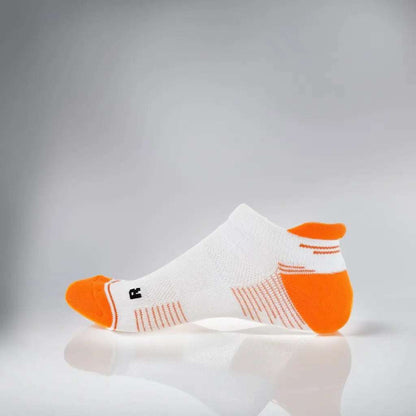 White and orange tennis low-cut socks with breathable mesh and secure fit strip for summer performance